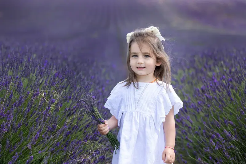 Girl in a white dress standing in a lavender field