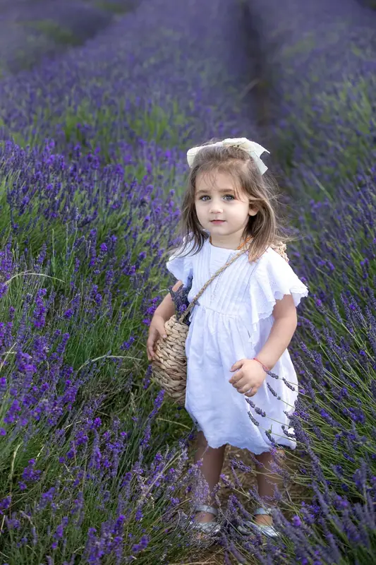 Girl in white walking through a lavender field