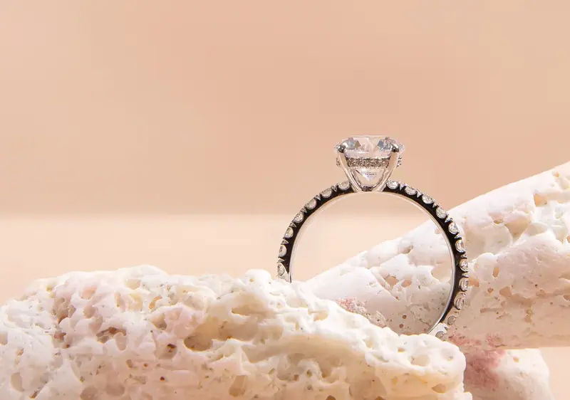 Diamond solitaire ring standing on white coral