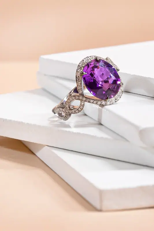 Purple gemstone ring on stacked white blocks