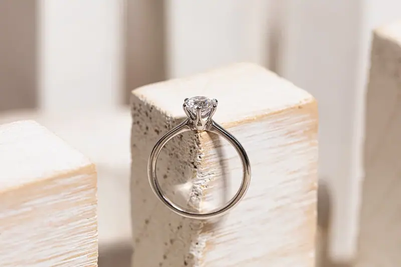 Diamond ring standing on a white wooden block