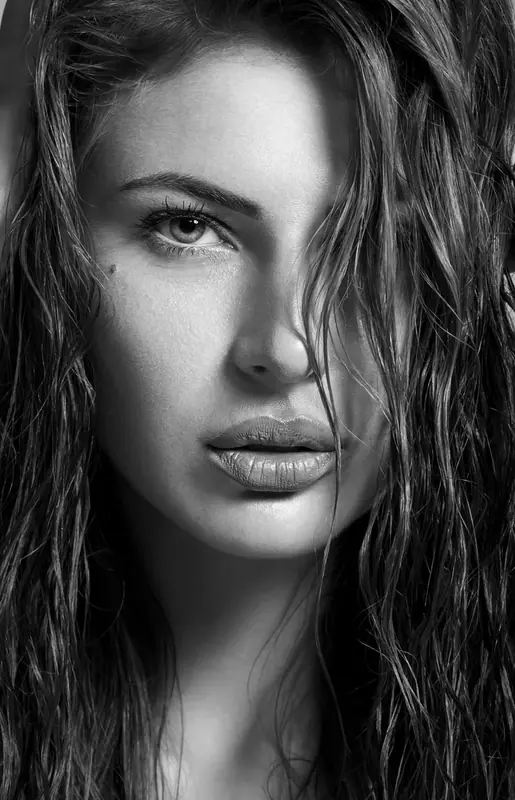 Black and white close-up portrait of a woman with wet hair