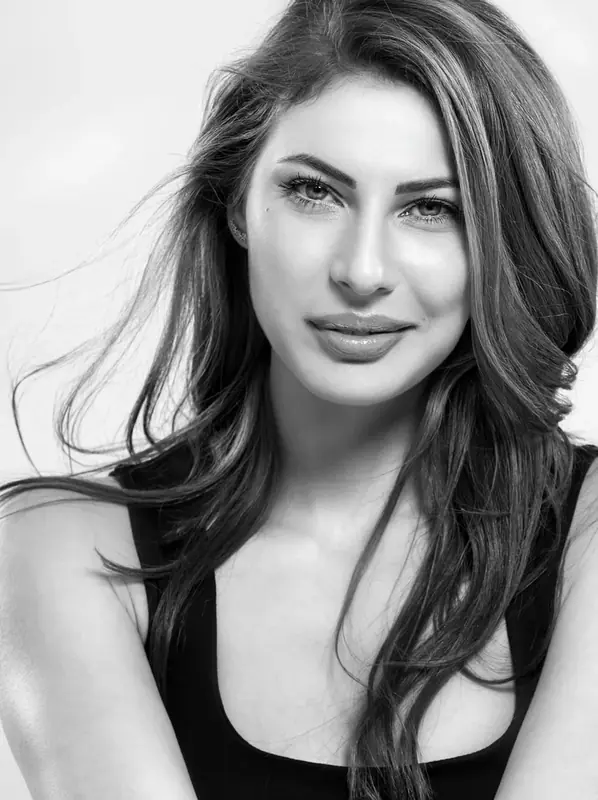 Black and white headshot of a woman with long dark hair